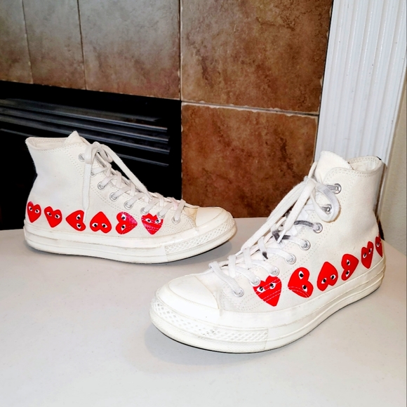 white sneakers with red heart and eyes